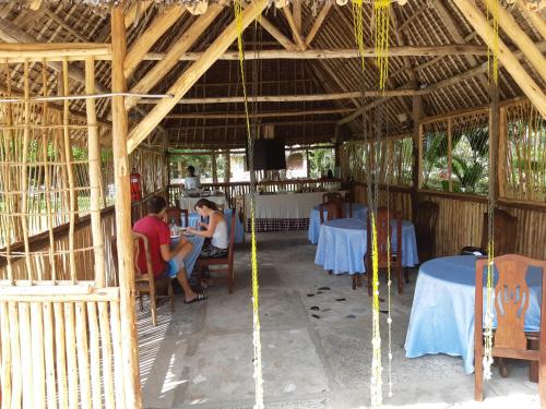 a group of people sitting at tables in a restaurant at Kijiji Beach Resort in Dar es Salaam