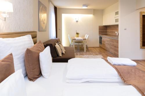 a bedroom with a bed and a living room at Főtér Rezidencia 2 in Győr