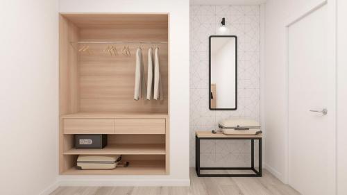a bathroom with a closet with a mirror and a sink at Palmanova Suites by TRH in Magaluf