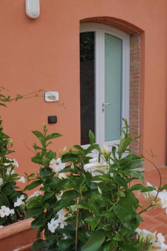 a door of a building with flowers in front of it at Agriturismo Due Comuni in San Gervasio