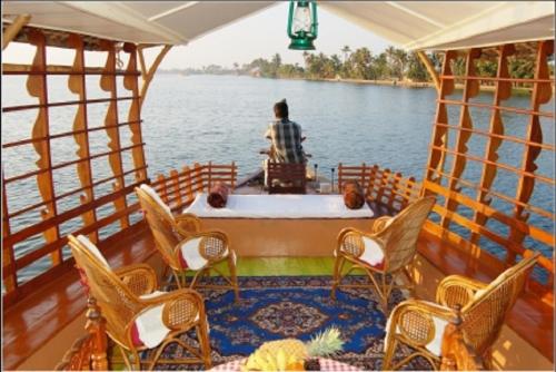 a person sitting in a bath tub on a boat at Warmth Lake Haven in Alleppey
