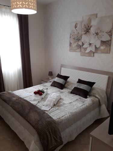 a bedroom with a large bed with flowers on it at A casa di Simona in Monreale