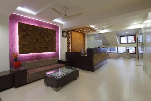 a living room with a couch and a table at Hotel Good Night in Ahmedabad