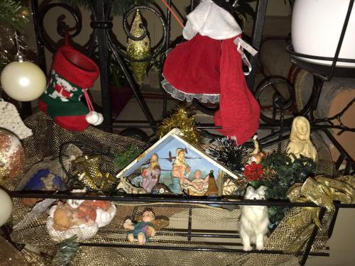 a table topped with christmas figurines and a cat at Hotel Nais in Durrës
