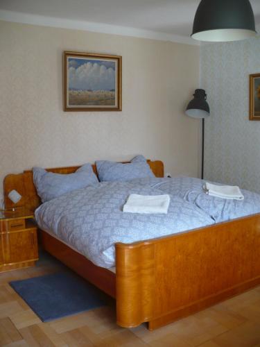 a bedroom with a bed with two towels on it at Chalupa Na Bidýlku in Jindřichŭv Hradec