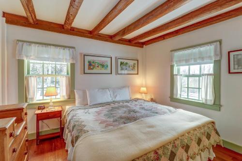 a bedroom with a large bed and two windows at Mount Holly Home in Mount Holly