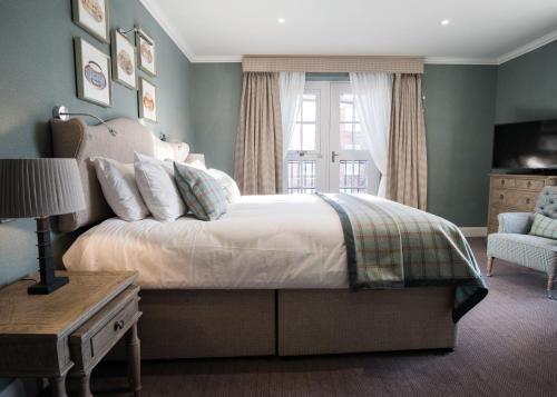 a bedroom with a large bed and a window at The Beverley Arms Hotel in Beverley
