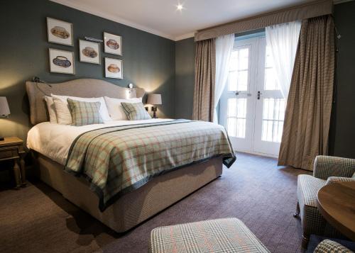 a bedroom with a bed and a large window at The Beverley Arms Hotel in Beverley