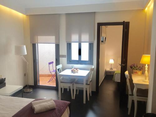 a room with a table and a dining room at Barcelona Fifteen central Aparthotel in Barcelona