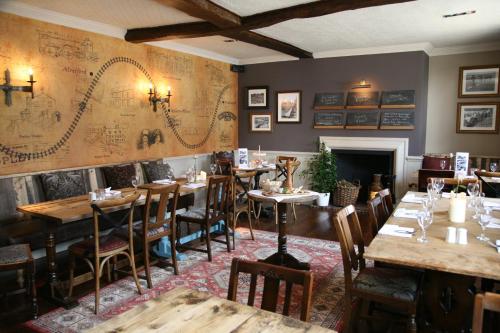 a restaurant with tables and chairs and a map on the wall at The Swan Hotel, Alresford in Winchester