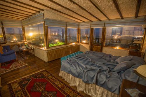 a bedroom with a bed and a view of a city at Karlık Evi Hotel - Special Category in Uchisar