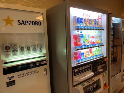 an open refrigerator with sodas and drinks in it at Hokkai Hotel in Lake Toya