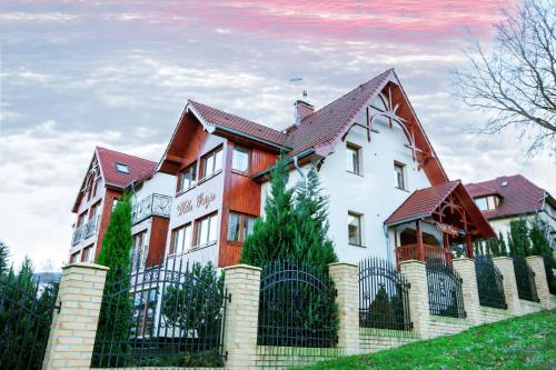 a large house with a fence in front of it at Willa Ostoja in Świeradów-Zdrój