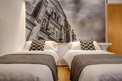 Posteľ alebo postele v izbe v ubytovaní VITORES Apartamentos Turísticos
