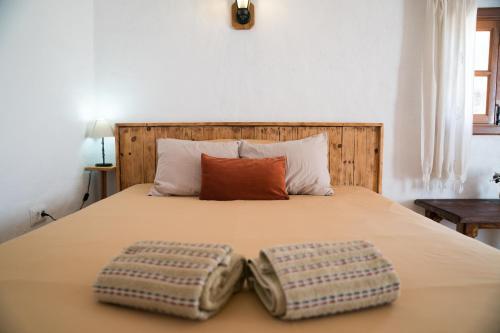 a bed with two pillows on top of it at El Cerro de la Luna in Arona