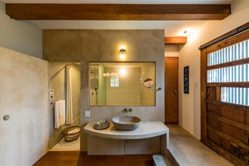 a bathroom with a sink and a mirror at The Bath & Bed Hayama in Hayama