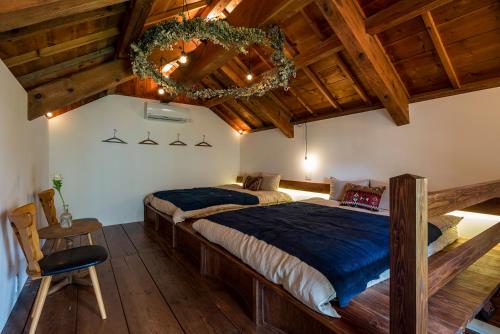 a bedroom with a large bed in a room with wooden ceilings at The Bath & Bed Hayama in Hayama