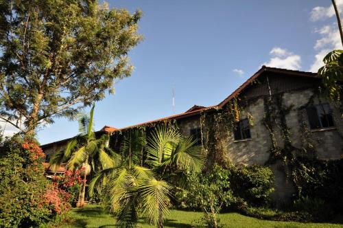 a house with palm trees in front of it at La Mada Hotel in Nairobi
