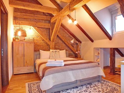 a bedroom with a bed in a room with wooden ceilings at Wood House Republicii in Braşov