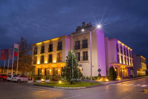 a building with a christmas tree in front of it at Parish Hotel in Svilengrad