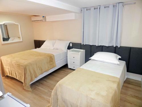 Un pat sau paturi într-o cameră la Flats Ouro Gramado Localizado a 900 metros da entrada do Centro de Gramado