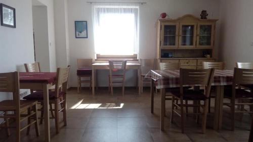 a dining room with a table and chairs and a window at Rekreace Zelba in Strážné
