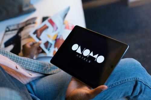 a person holding a tablet with the amazon logo on it at ONOMO Hotel Casablanca Sidi Maarouf in Casablanca