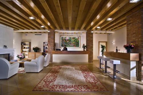 a large living room with a fireplace and a table at Ca' Murà Natura e Resort in Maserà di Padova