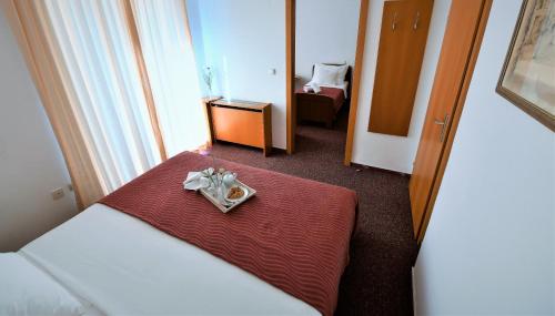 a hotel room with a table with a plate of food at Hotel Alkar in Sinj