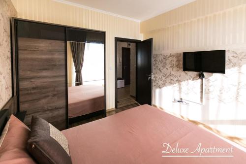 a bedroom with a bed and a television and a bed at Apartment Cathedral Deluxe in Varna City