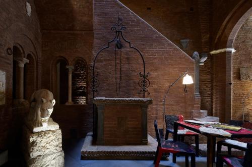 a room with a statue of a head and a table at Palazzetto Rosso - Art Hotel in Siena