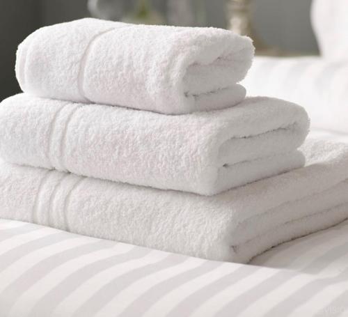a stack of white towels stacked on a bed at The Punchbowl Inn in Thorne