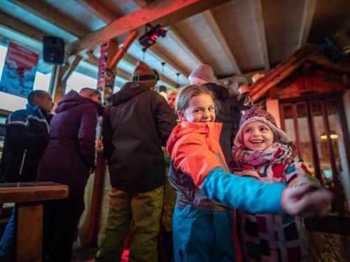 two little girls are standing in a room at Hotel Edelweiss in Nendaz