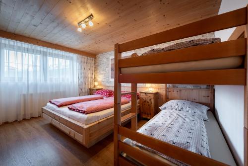 a bedroom with two bunk beds in a cabin at Familie Sponring - Maxnhagerhof in Weerberg