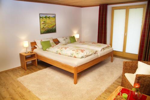 a bedroom with a bed and a couch at Ferienwohnung Jörg in Bad Hindelang