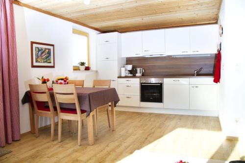 a kitchen with a table and chairs in a room at Ferienwohnung Jörg in Bad Hindelang