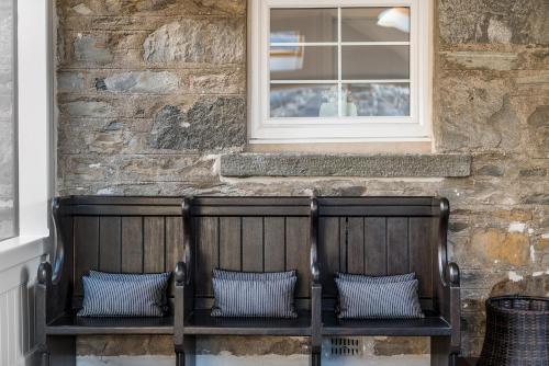 two wooden chairs sitting in front of a window at Dunalastair Hotel Suites in Kinloch Rannoch