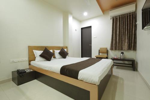 a bedroom with a large bed in a room at Hotel Good Night in Ahmedabad