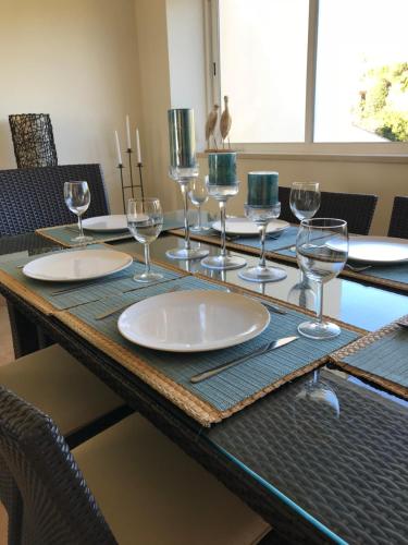 a table with empty wine glasses on top of it at OCEAN VIEW VILLA BELAMAR in Luz