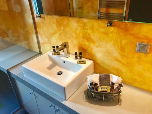 a bathroom with a white sink and a mirror at Red Grey Sea View Villa in Schinias