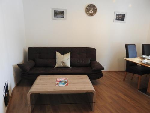 a living room with a couch and a coffee table at Bergschlössl in Goldegg