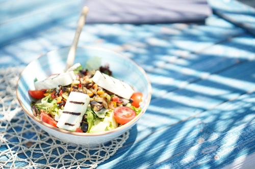 a salad in a bowl on a table at Yacht Classic Hotel - Boutique Class in Fethiye