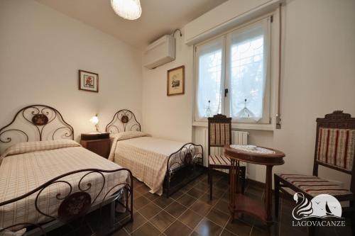 a bedroom with two beds and a window at Villa Solelago Exclusive in Lonato