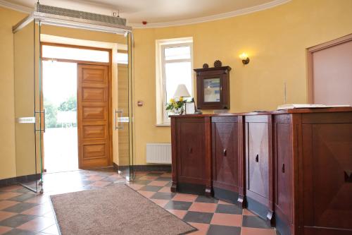 a room with a wooden cabinet and a door at Kolonna Hotel Rēzekne in Rēzekne