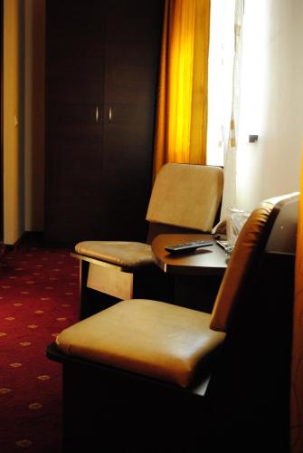 a room with two tables and chairs and a window at Casa Amurg in Sinaia