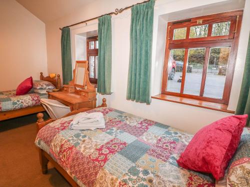 a bedroom with a bed and a window at Piggery Place in Buxton