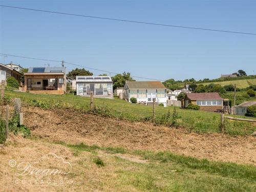 a view of a yard with houses in the background at The Wave in West Bay