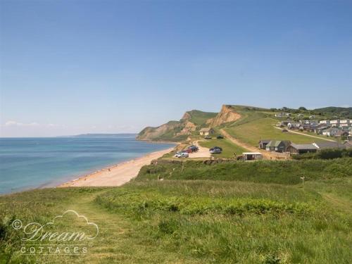 a view of a beach with houses and the ocean at The Wave in West Bay