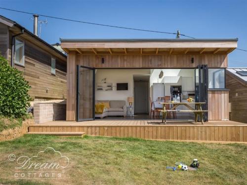 a house with a large sliding glass door at The Wave in West Bay