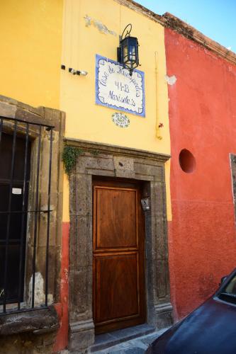 a building with a door and a sign on it at Casa Maricela B&B in San Miguel de Allende
